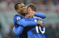 Patrice Evra (L) embraces Wayne Rooney (