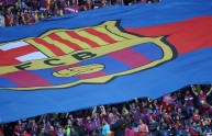 A giant FC Barcelona’s flag is hold by t