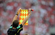 A linesman holds up a flag during the Ge