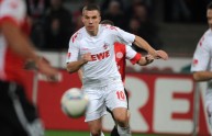 Cologne’s striker Lukas Podolski (C) rea