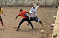 Youths play football in a Malabo suburb